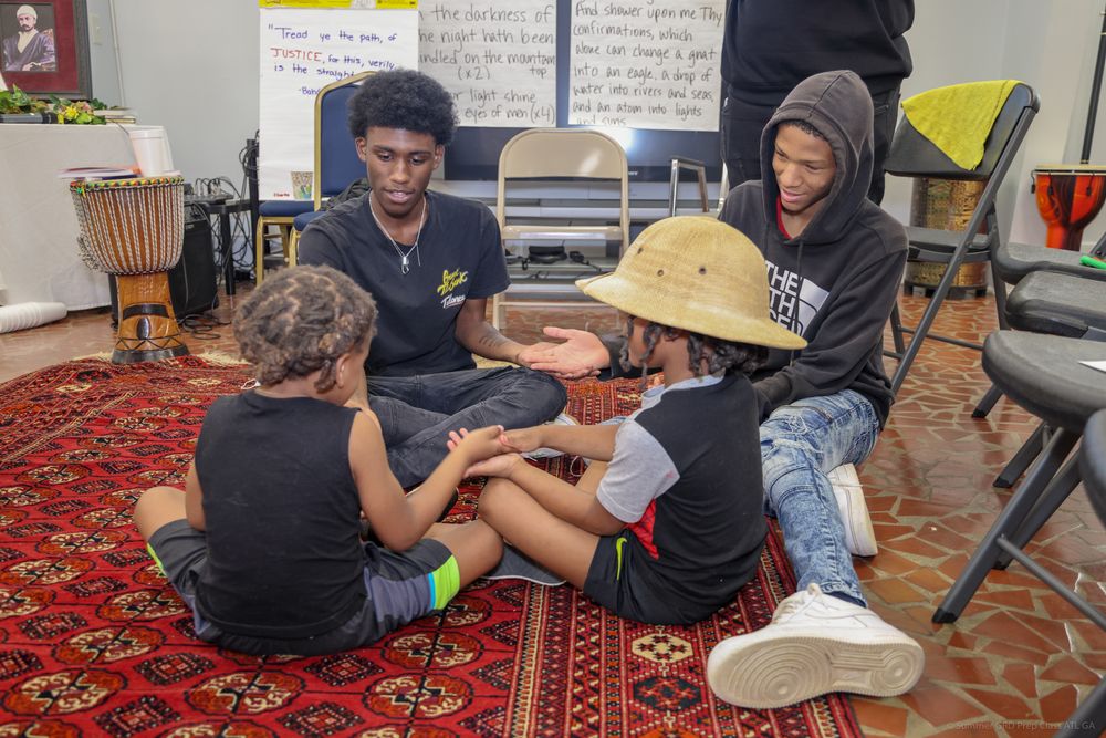 Photo of two youth playing with 2 children at the Baha'i Unity Center in Decatur GA